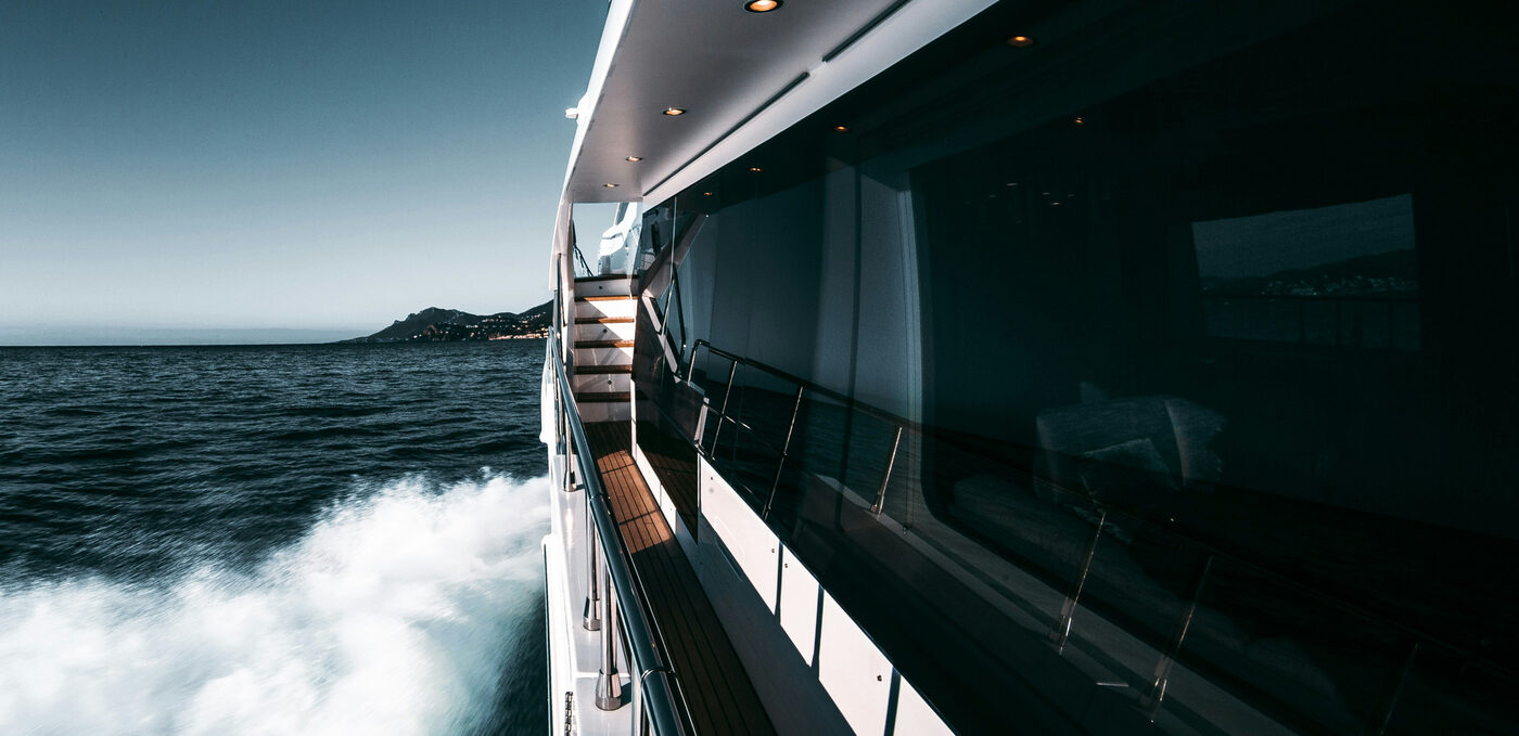 The side deck of a superyacht underway at sea